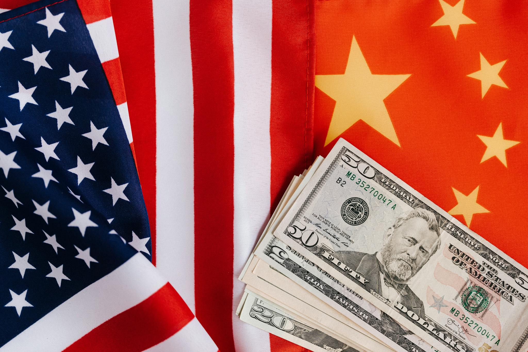 American and Chinese flags and USA dollars